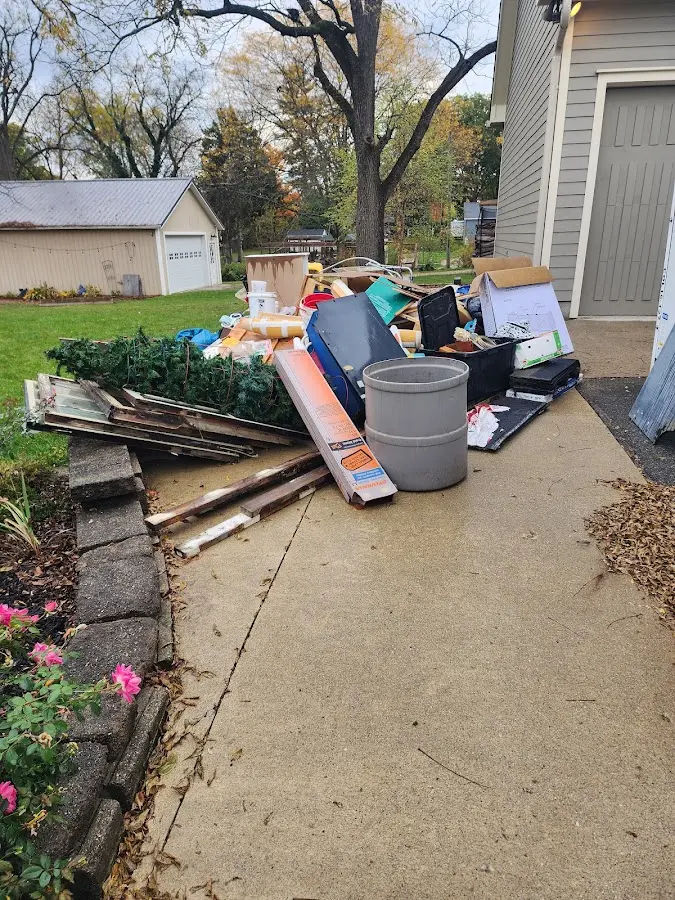 Dumpster being loaded with debris for Estate Cleanout Dumpster Rental in Alton